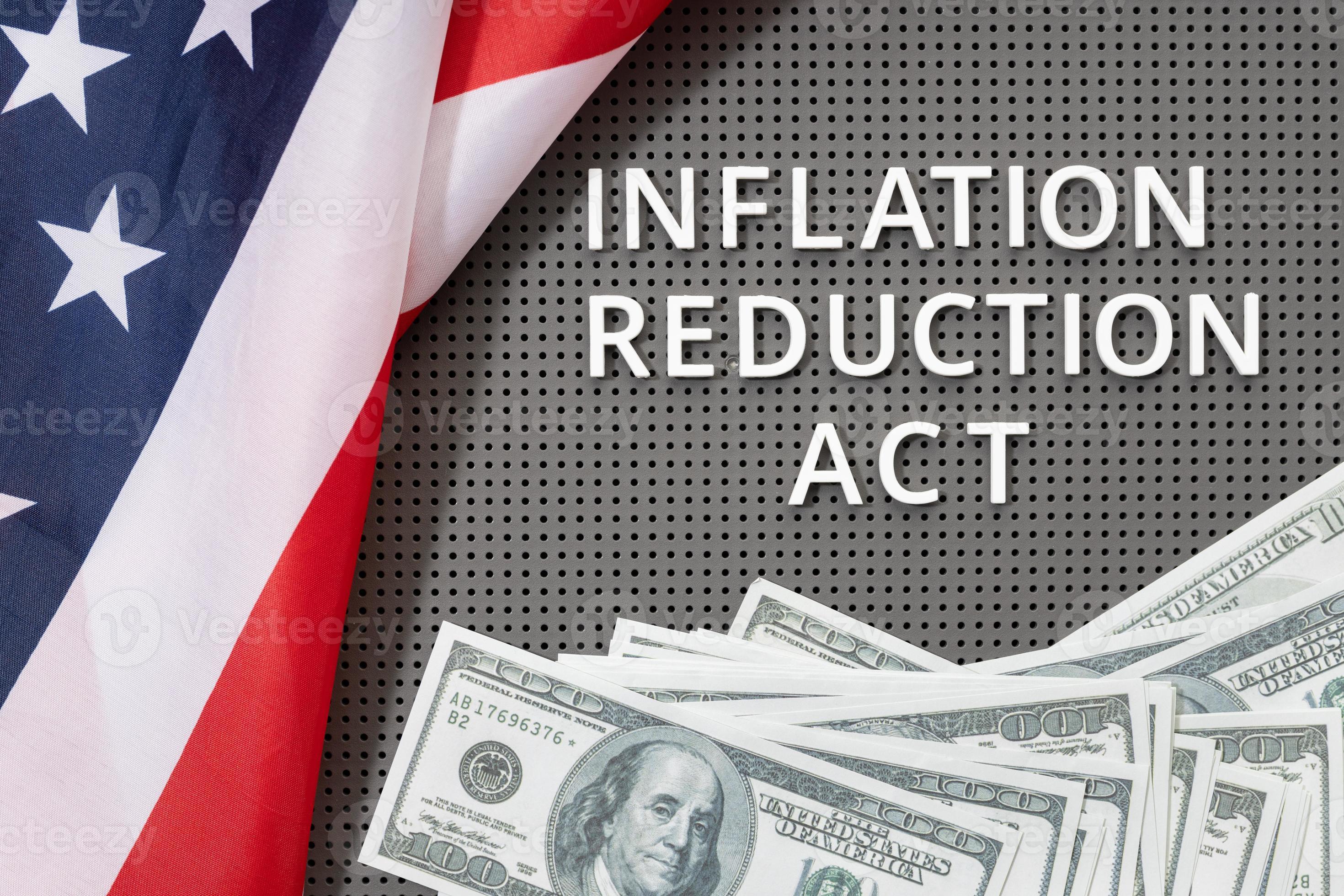 Inflation reduction Act law concept. Fat lay of text, american flag and