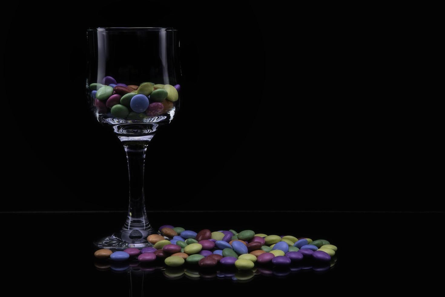 Glass with colored candies photo