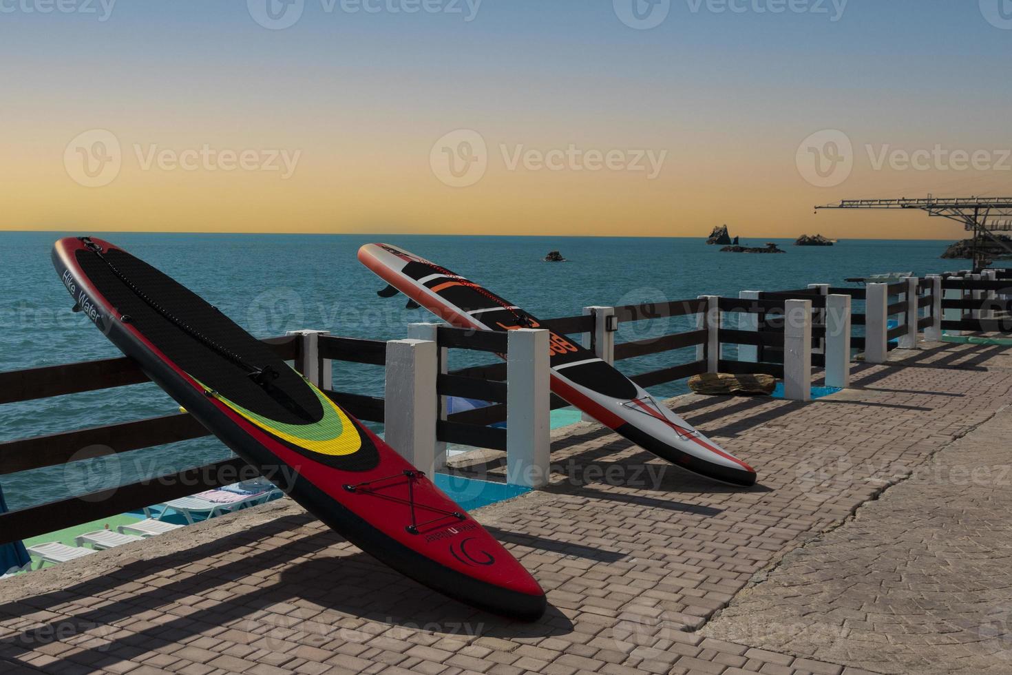 SUP board on the embankment at dawn without people. photo