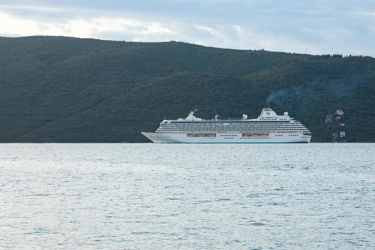 Bay of Kotor, Montenegro - October 21, 2020  Cruise ship Crystal Serenity in the Bay of Kotor. The entire ship is visible. Rocky cliffs and blue sky. photo