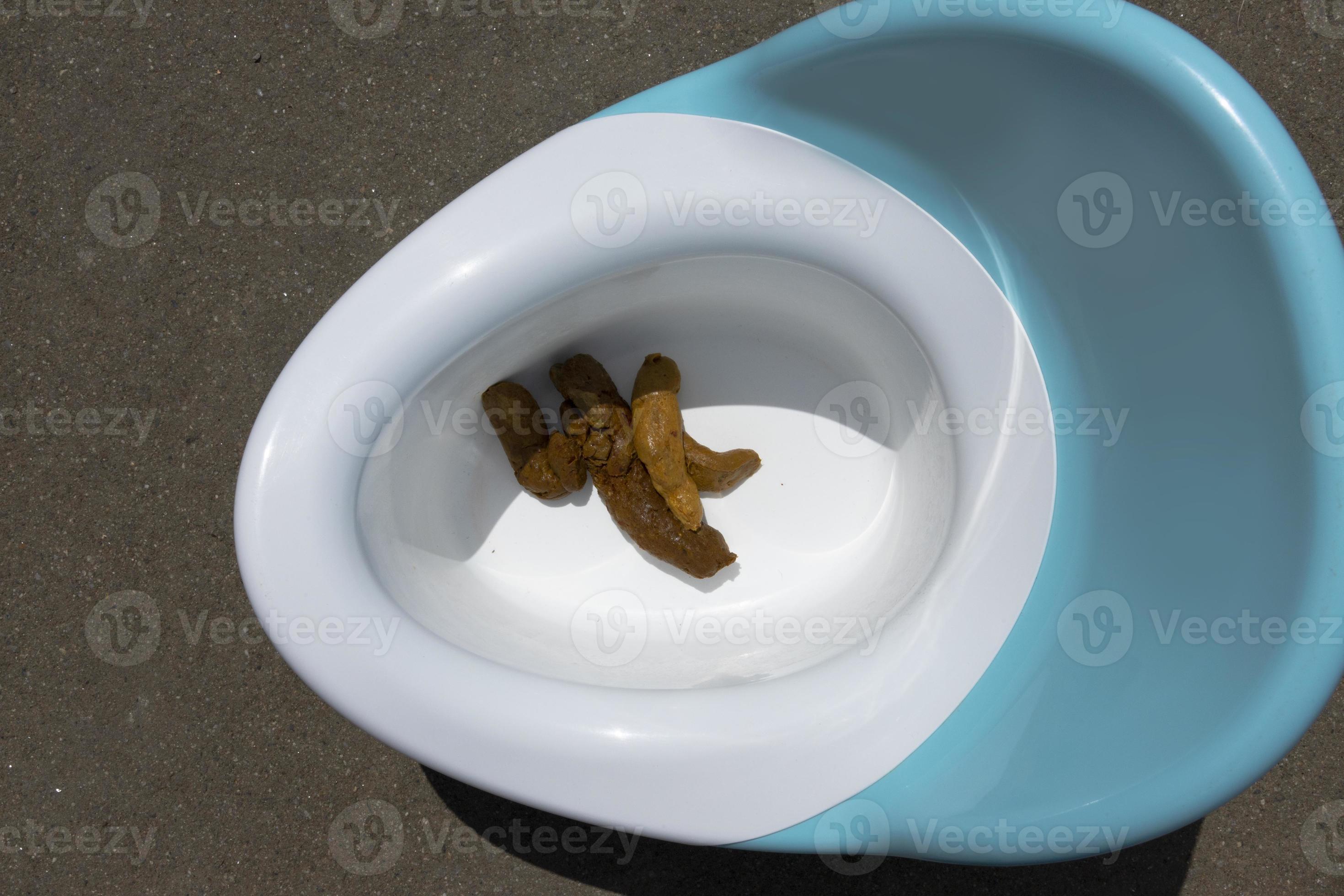 Blue baby potty with excrement, feces, a child of one and a half years