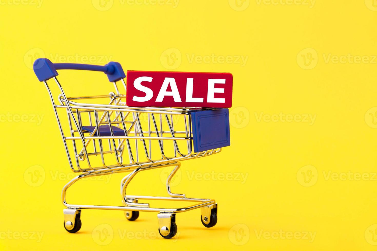 Empty mini shopping trolley, shopping cart, with text SALE on yellow background. RFI Request for information. copy space photo