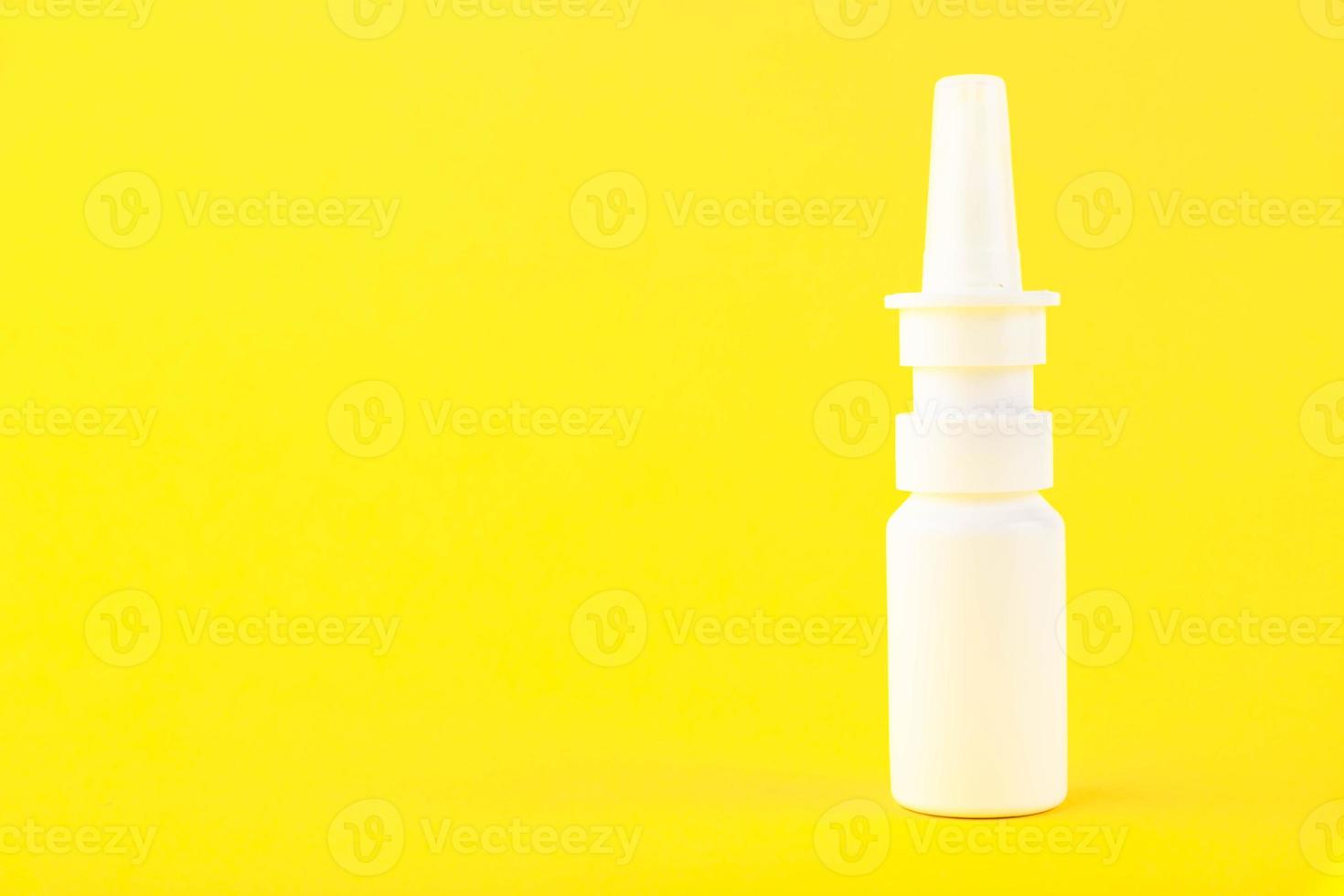 Medicinal nasal spray, white plastic medical packaging, container isolated on yellow background. Copy space photo