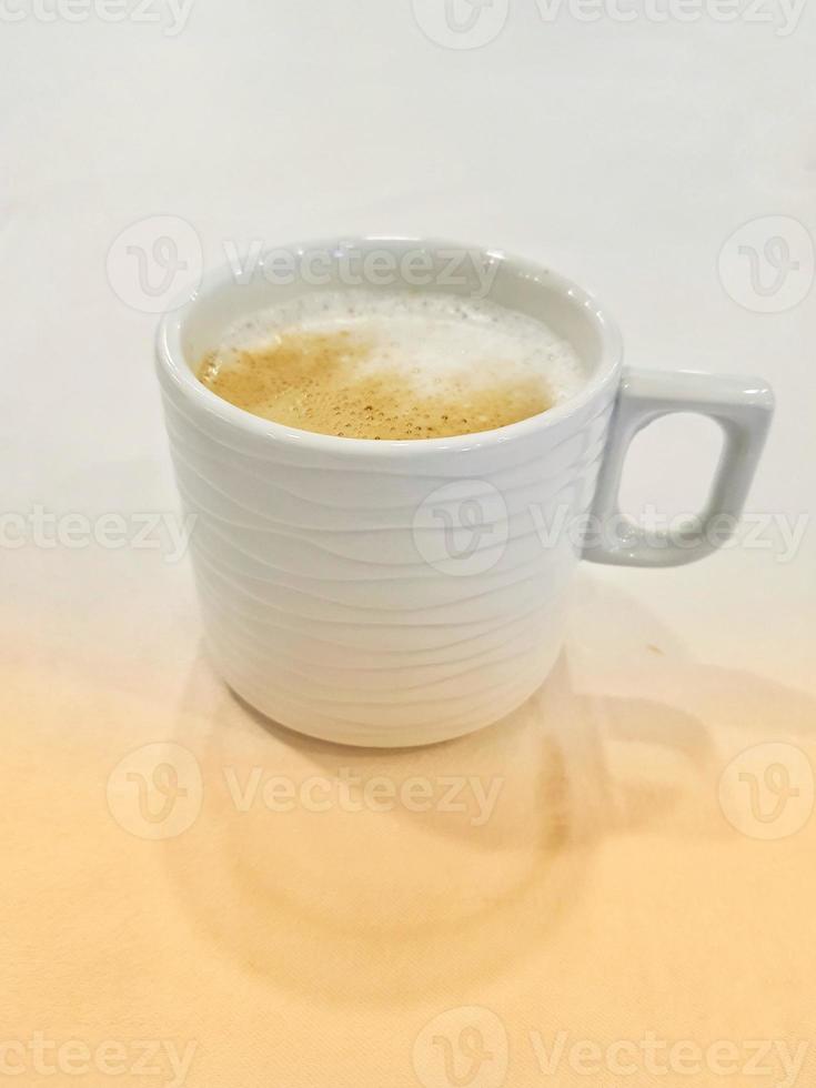 A glass of warm cappuccino photo