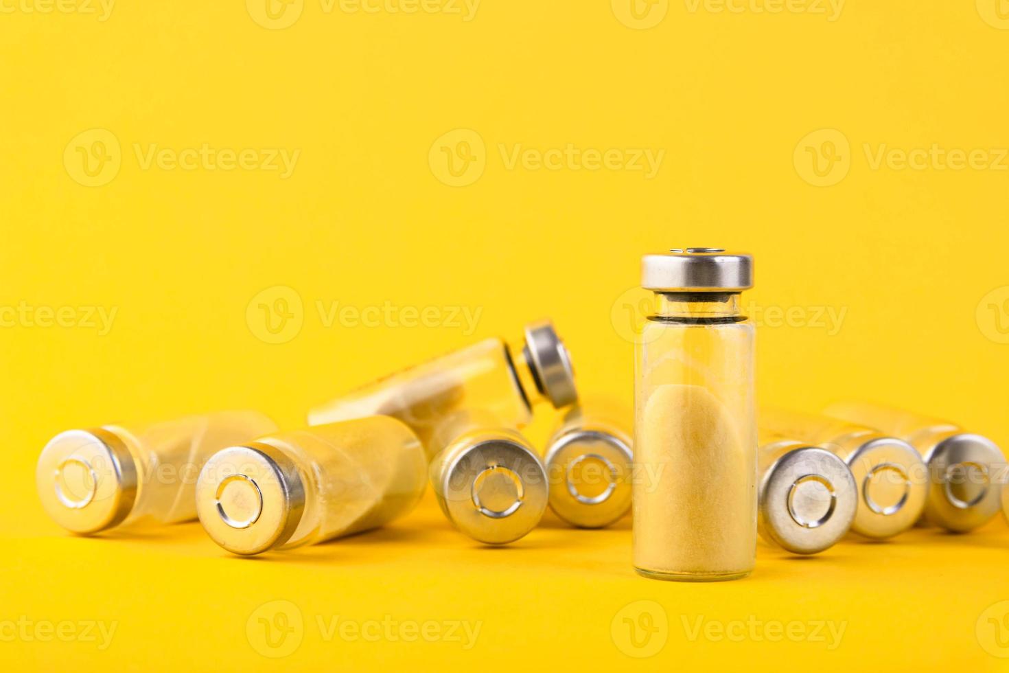 Bubbles, ampoules with dry probiotic, bifidobacteria, with probiotic powder inside on a yellow background. Copy space. photo