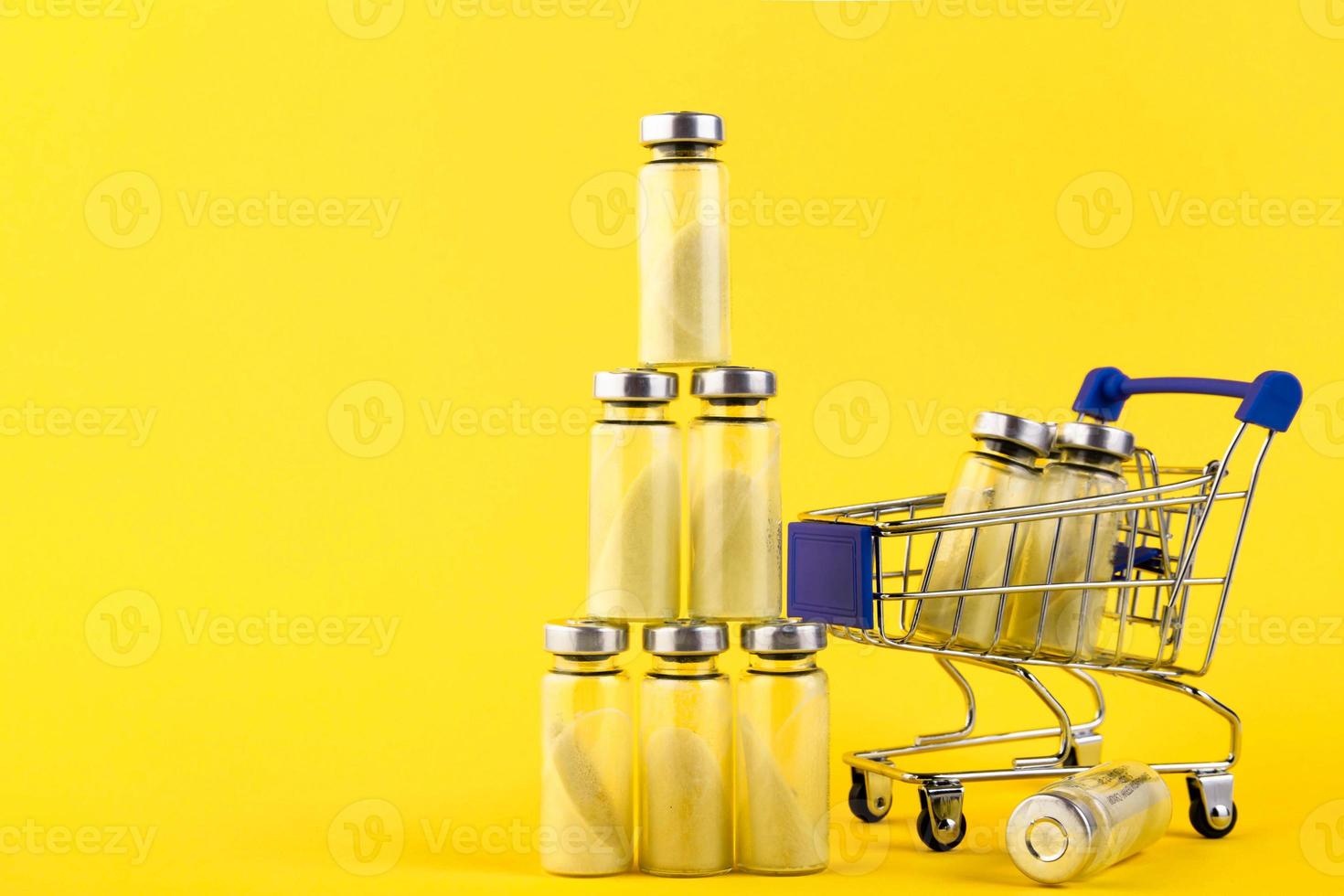 Vials, ampoules with dry probiotic, bifidobacteria, with probiotic powder inside, on a supermarket trolley. on a yellow background. photo