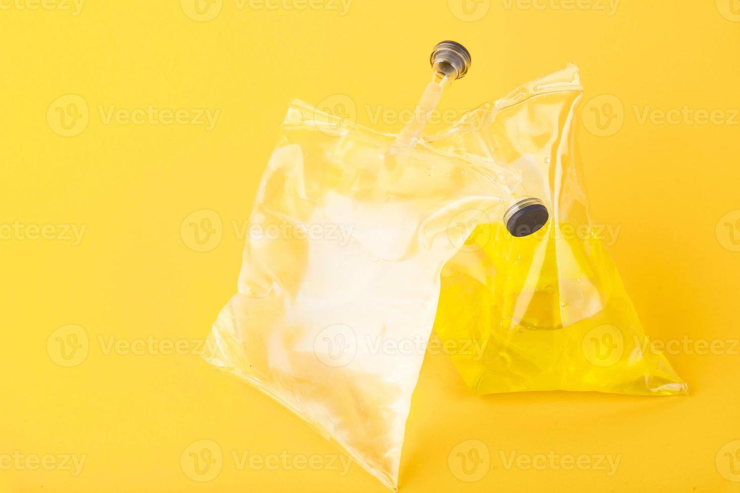 Medical saline solution, furacilin isolated on yellow background in soft silicone packaging. photo