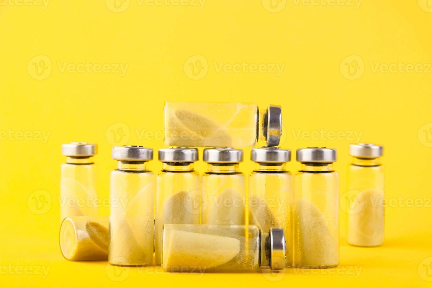 Bubbles, ampoules with dry probiotic, bifidobacteria, with probiotic powder inside on a yellow background. Copy space. photo