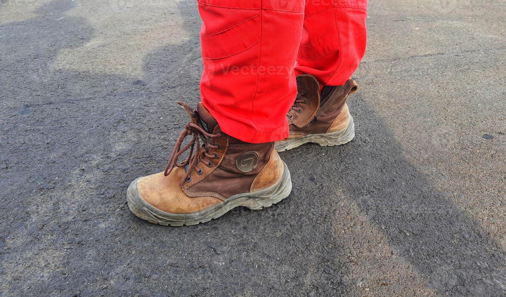 Healthy safety and environmental officers who wear red pants uniforms and brown safety shoes. photo