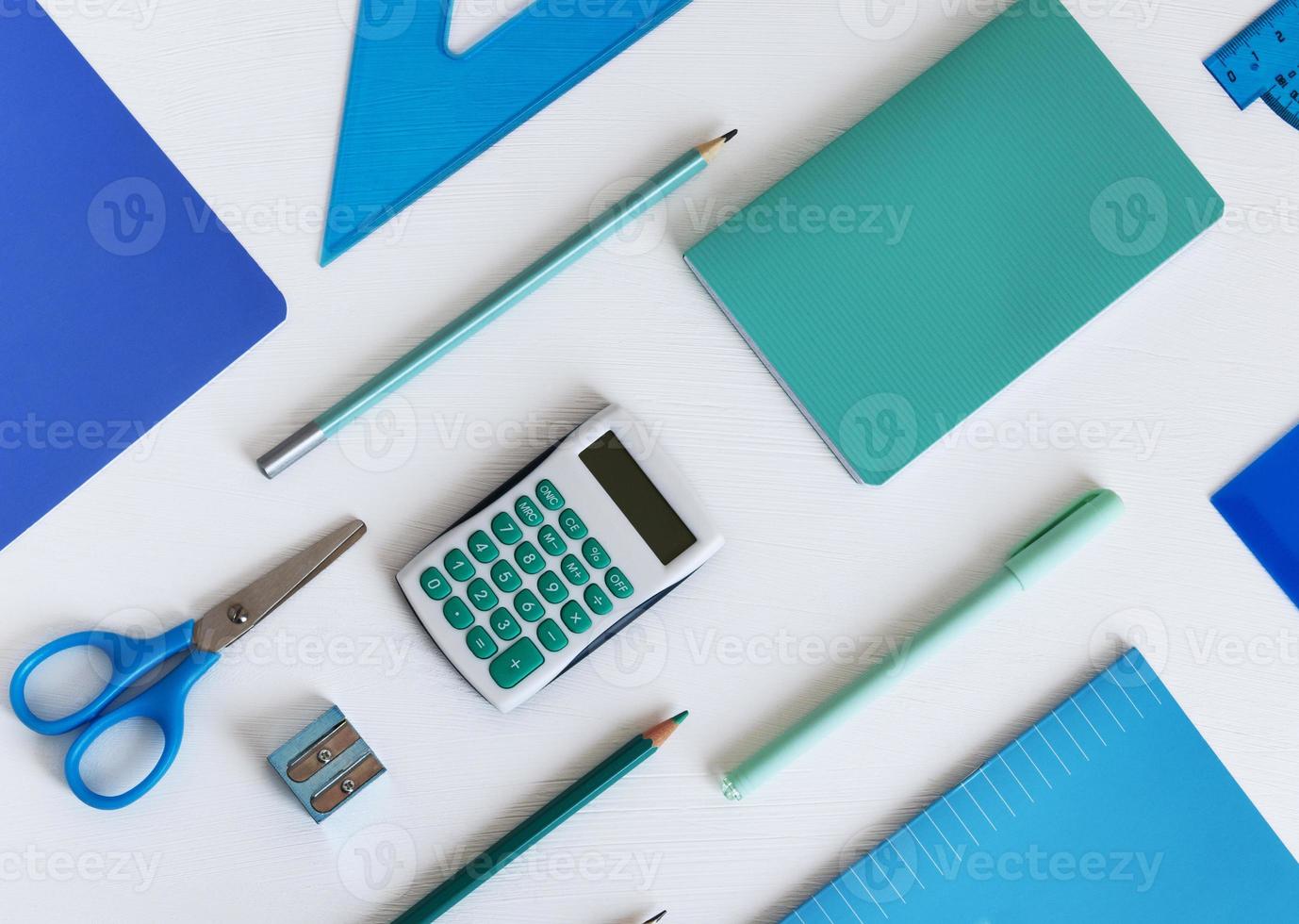 Background with blue office supplies. Folder, notebook, notebook, pencil in different shades of the same color photo
