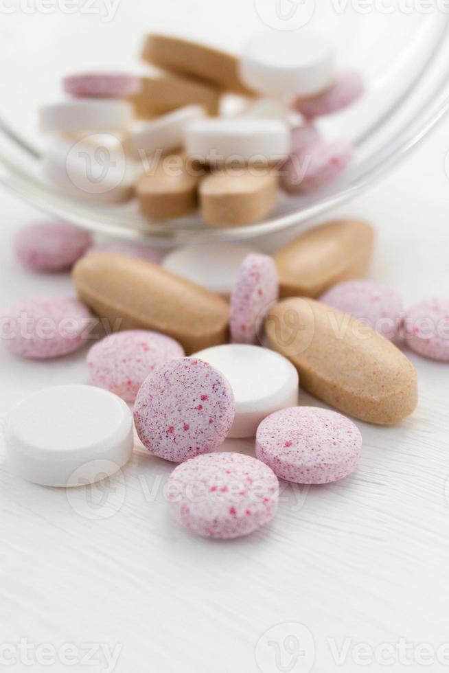 Medical various pills on light background. Selective focus. Heap surface close up top view. photo