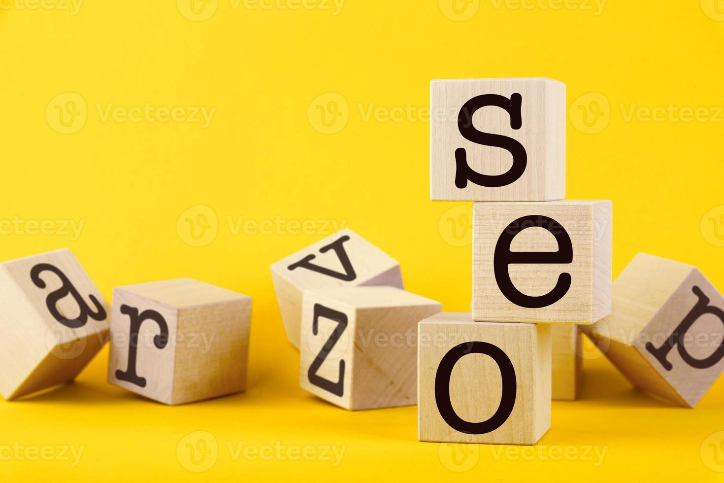 SEO, search engine optimization, text wooden cube blocks on yellow background. Idea, vision, strategy, analysis, keyword and content concept photo