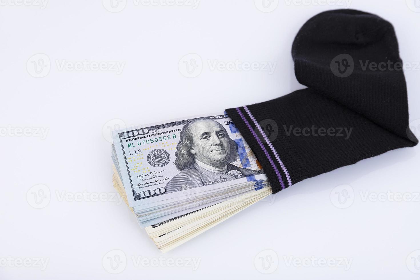 Money sock. a bundle of American hundred dollar bills hidden in a sock. Savings and storage concept. Selective focus photo