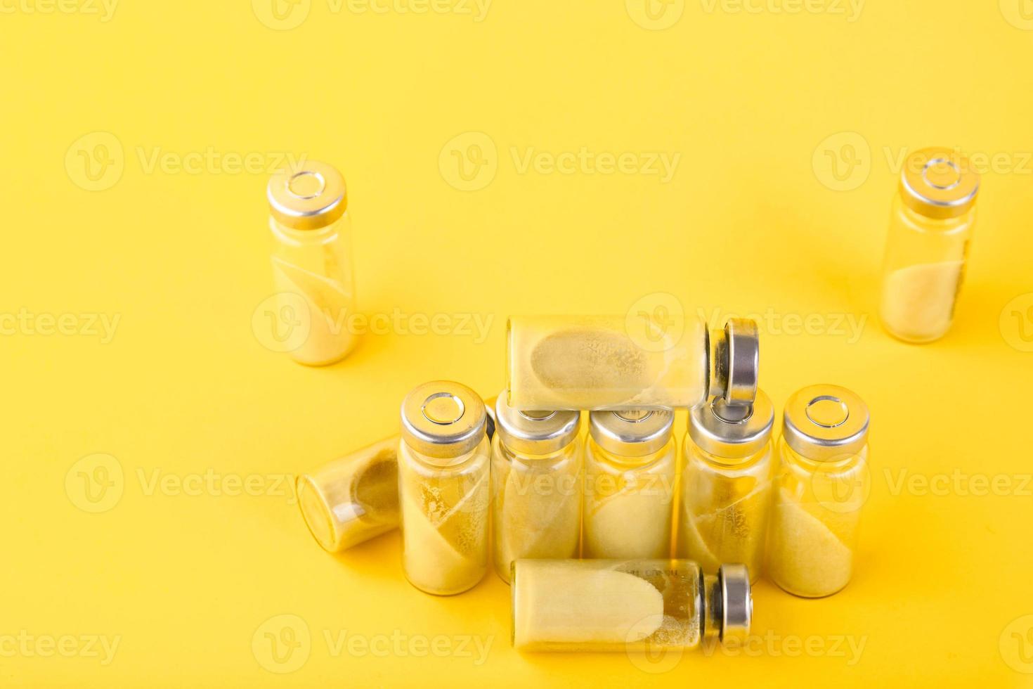 Bubbles, ampoules with dry probiotic, bifidobacteria, with probiotic powder inside on a yellow background. Copy space. photo