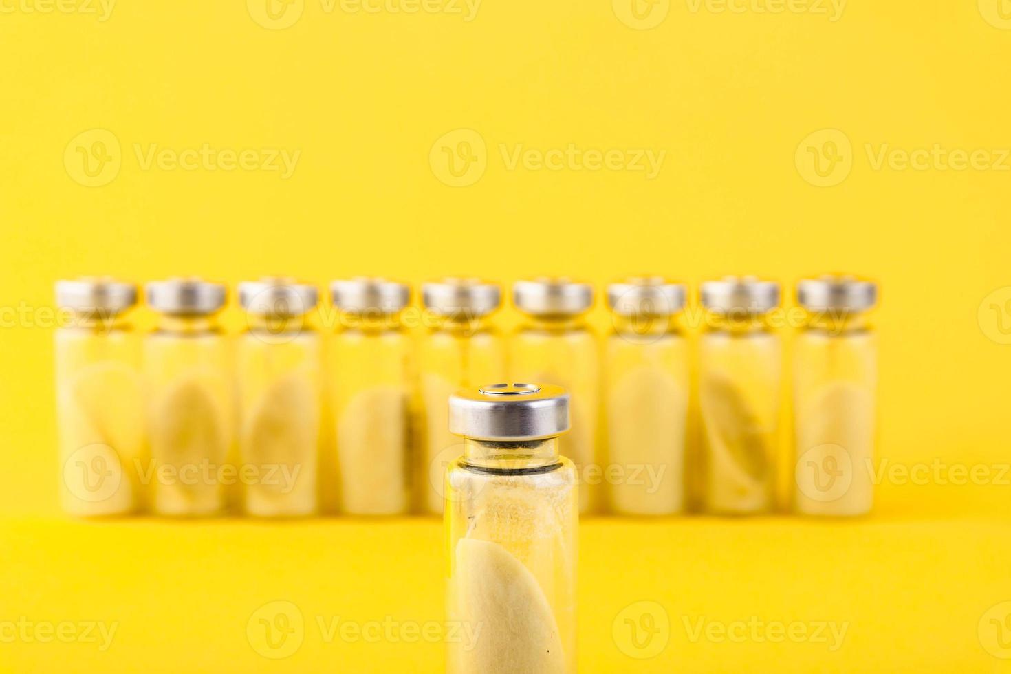 Bubbles, ampoules with dry probiotic, bifidobacteria, with probiotic powder inside on a yellow background. Copy space. photo