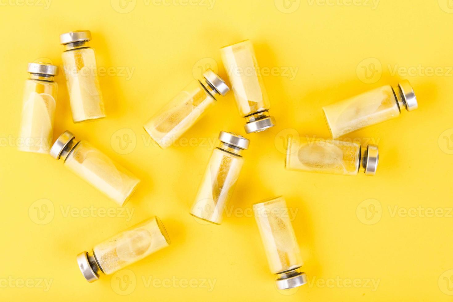 Bubbles, ampoules with dry probiotic, bifidobacteria, with probiotic powder inside on a yellow background. Copy space. photo