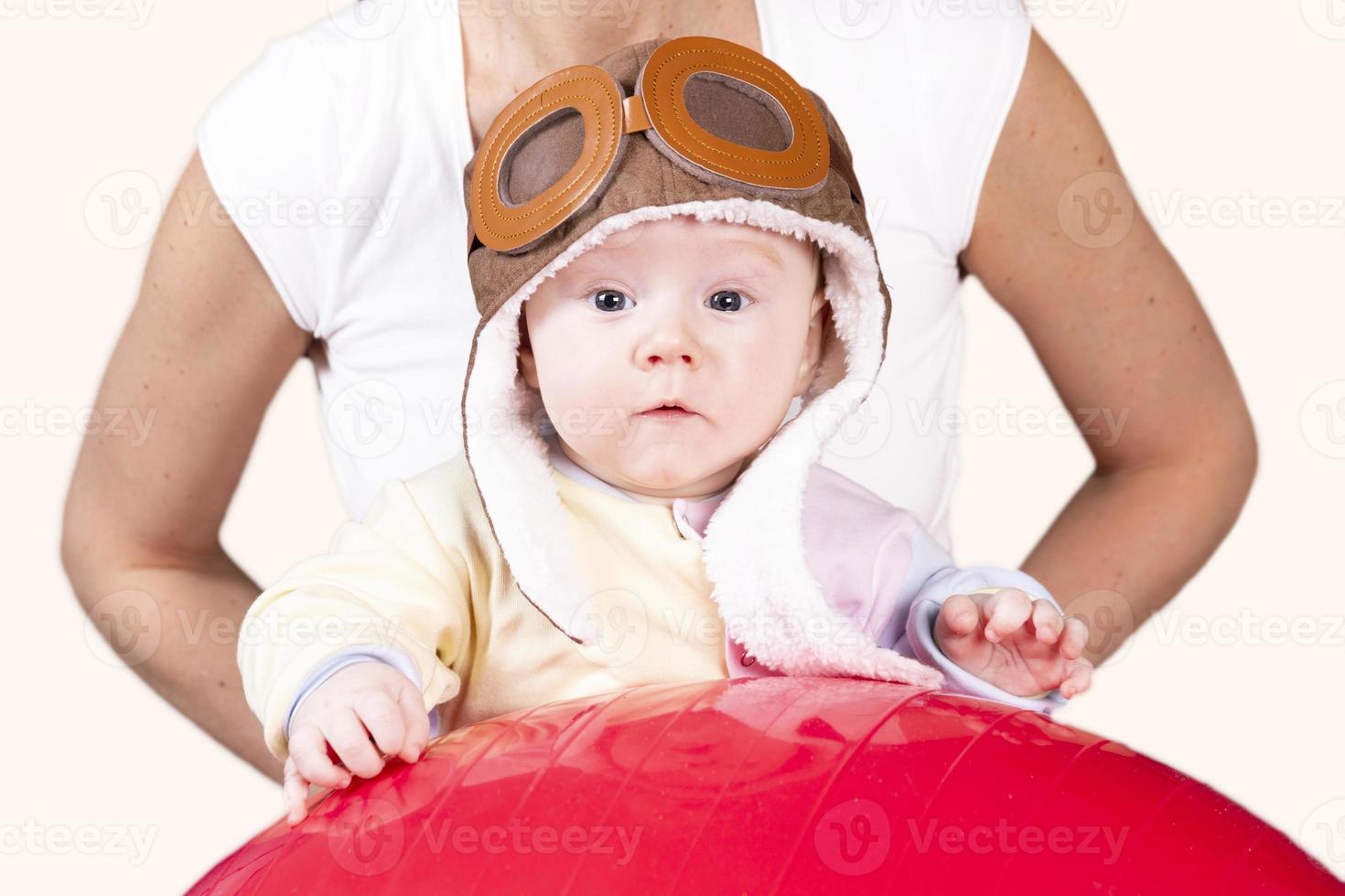 The child plays, does exercises, does gymnastics with his mother at home. photo