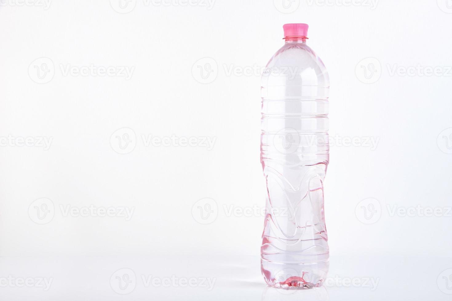 Plastic bottle of drinking water isolated on white photo