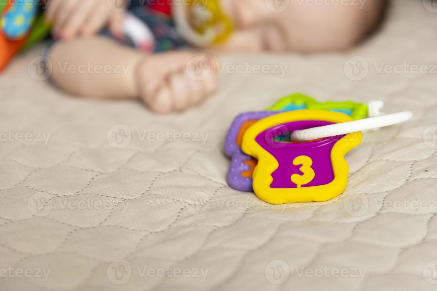 Sleeping cute baby, three months old, with toys. Selective focus. photo