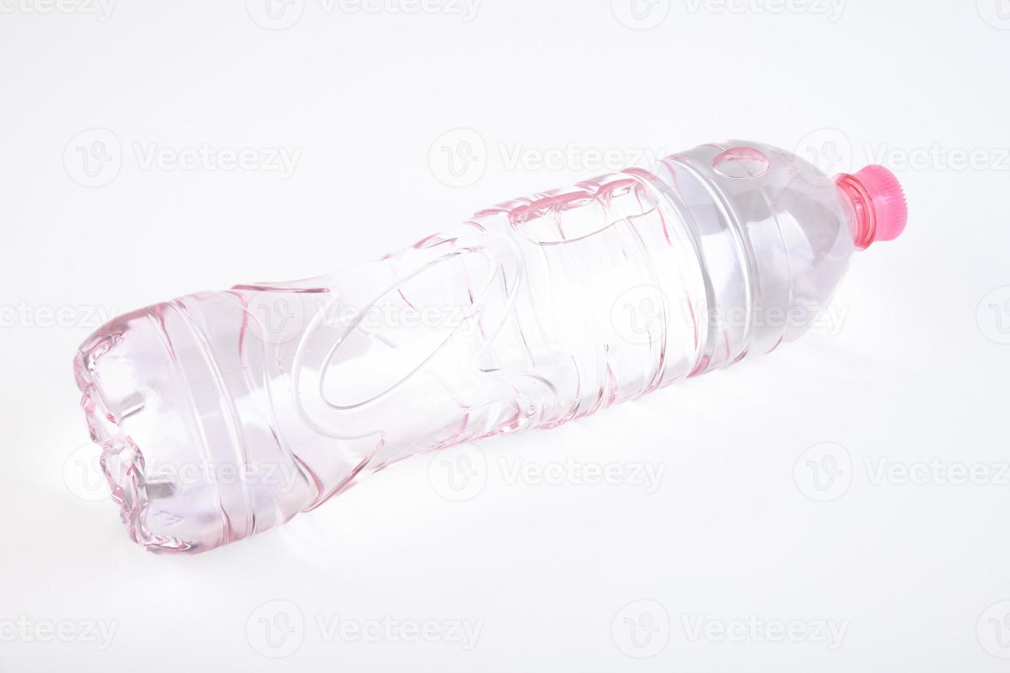 Plastic bottle of drinking water isolated on white photo