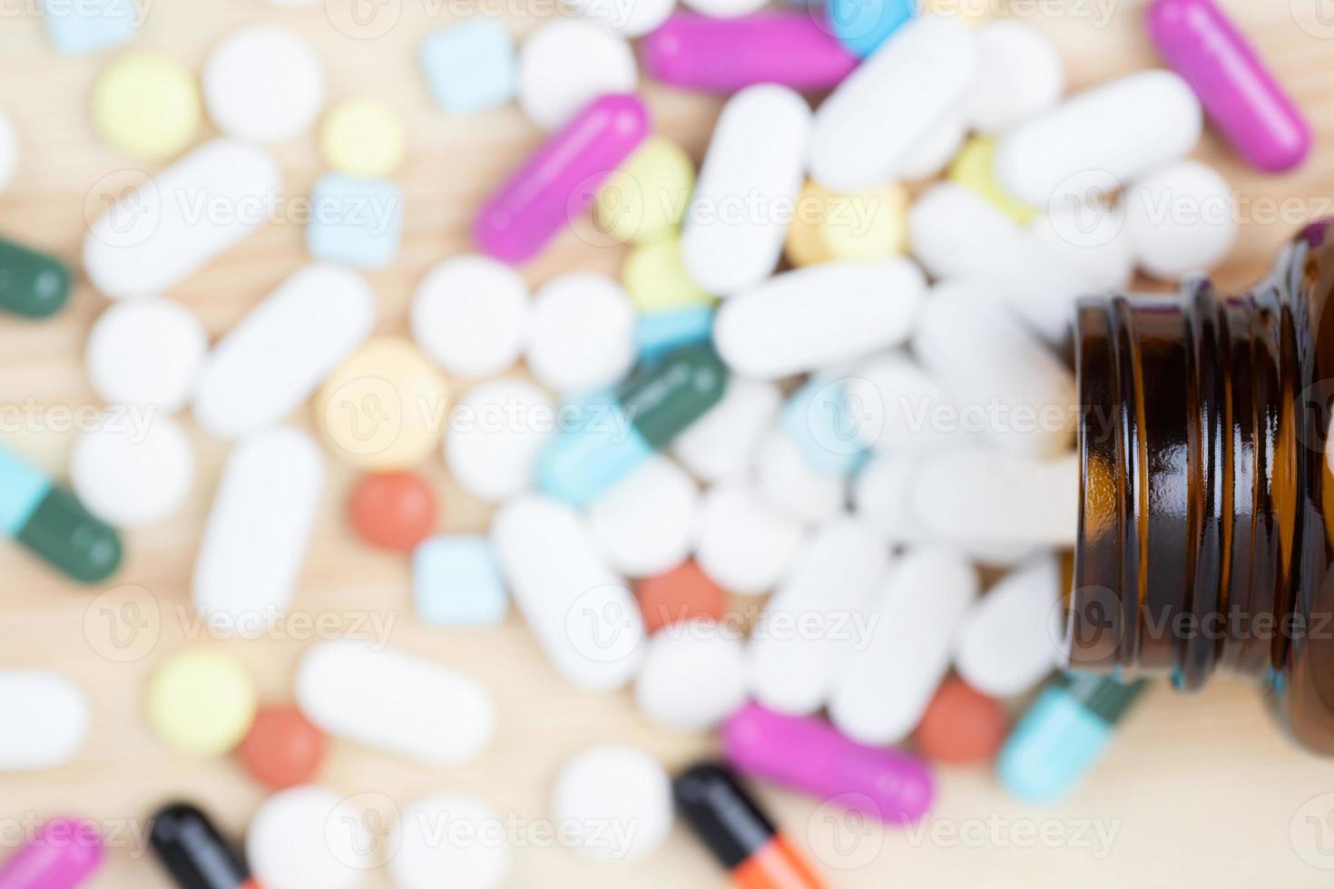 close up macro Pill spilling out disrupted. colorful pills capsule on to surface tablets on a white background. drug medical healthcare concept. photo