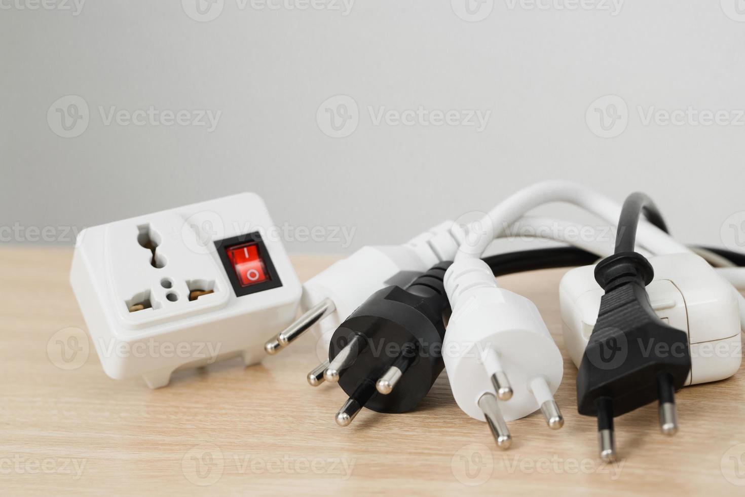 An extension socket is a device that consists of several components, such as a power cord, an electrical socket, an outlet, a power strip, and an electrical switch. photo