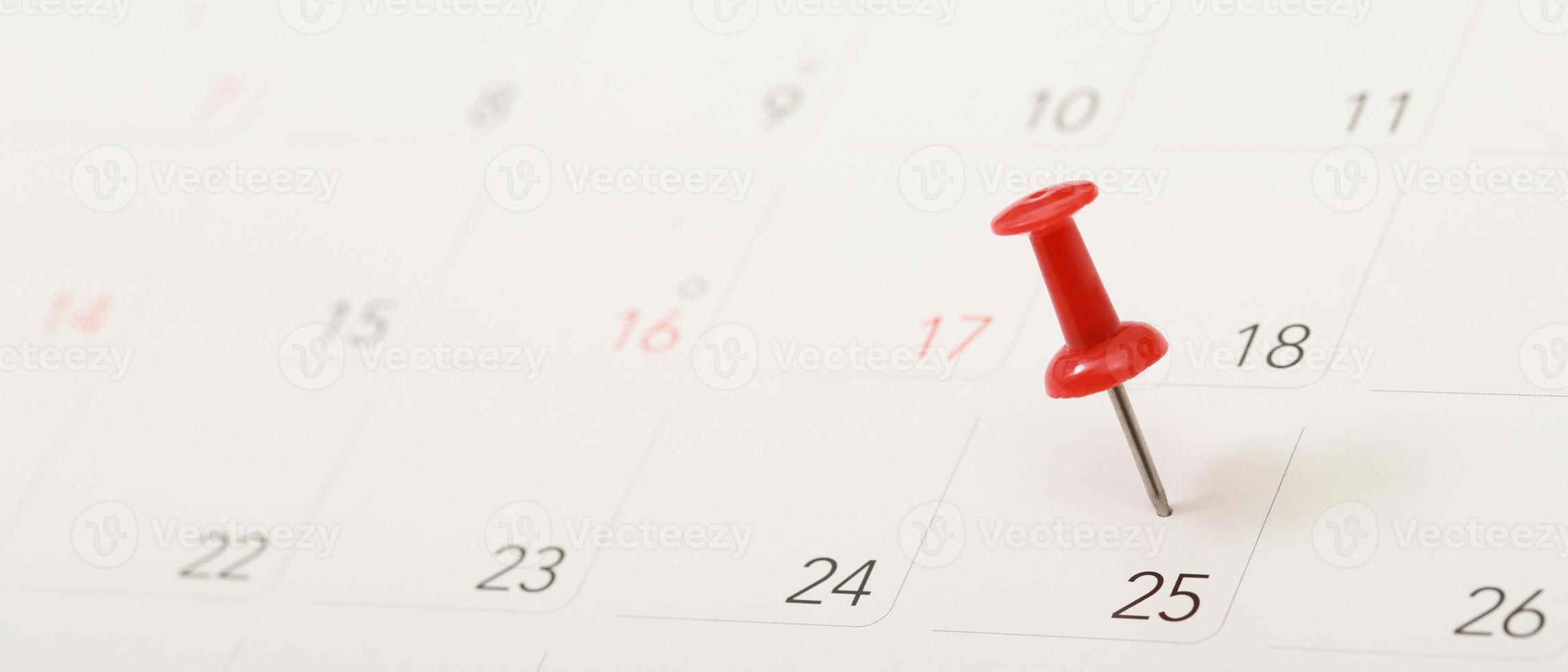 mark the event day with a pin red. Thumbtack in calendar concept for busy timeline organize schedule,appointment reminder. planning business meeting or travel holiday planning concept. soft focus photo