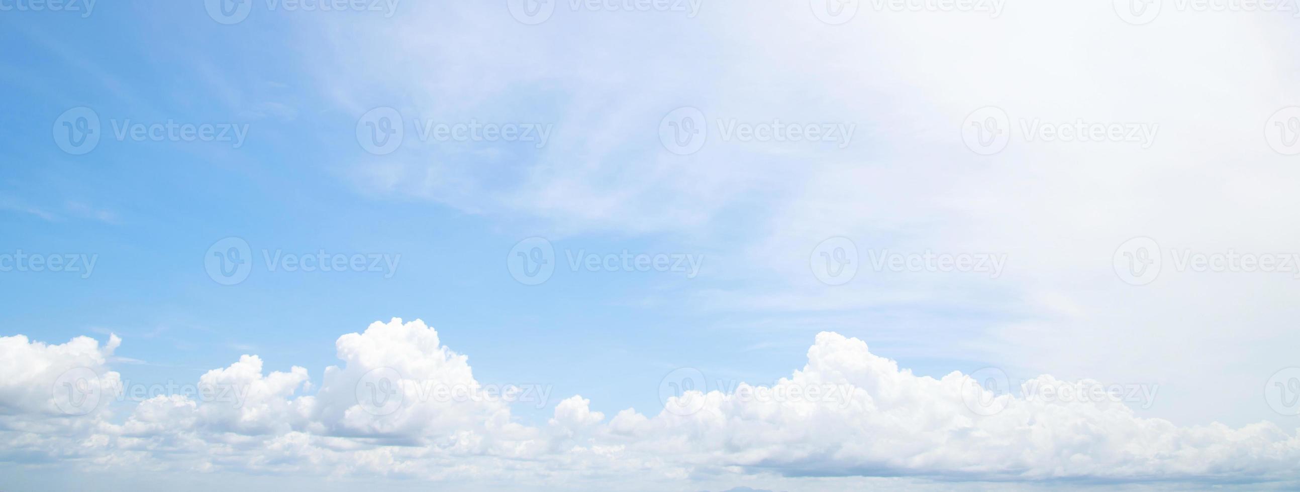 Beautiful clear blue sky background with tiny plain white cloud on morning time rays sunlight. space for text. soft focus. photo