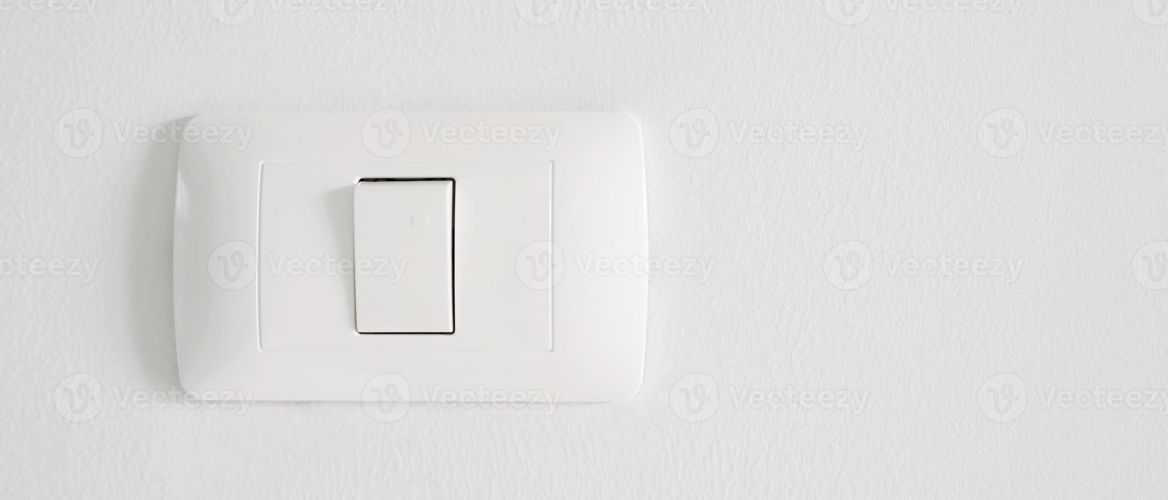 Electronic lighting switch with white wall background. home electrical power. photo