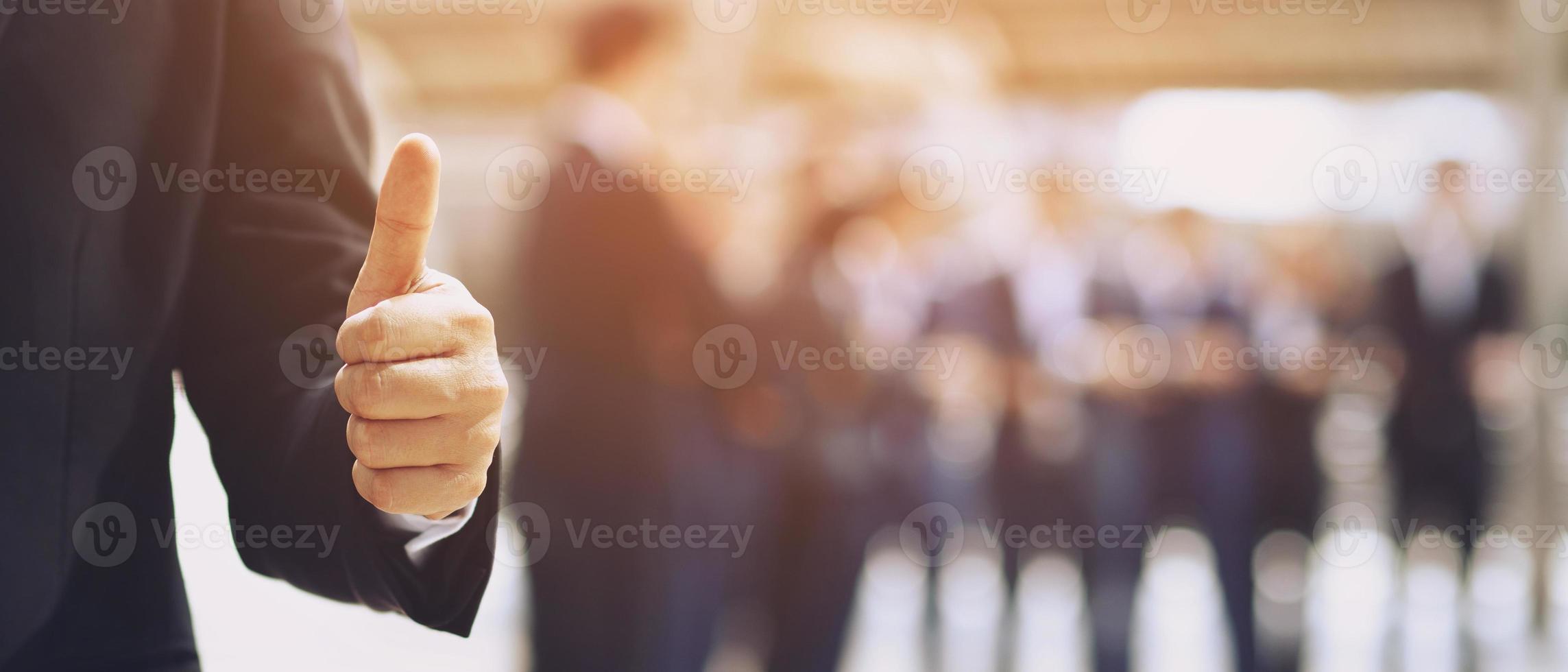 Happy cheerful Group of business people raising arms over thumb up office background successful entrepreneurs.  Success team achieving goals. photo