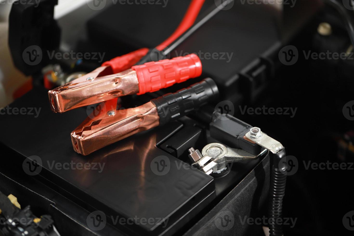 Safely charge the car battery with positive-negative terminals. photo