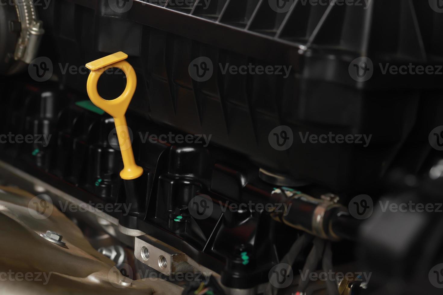 The mechanic is checking the engine oil. photo