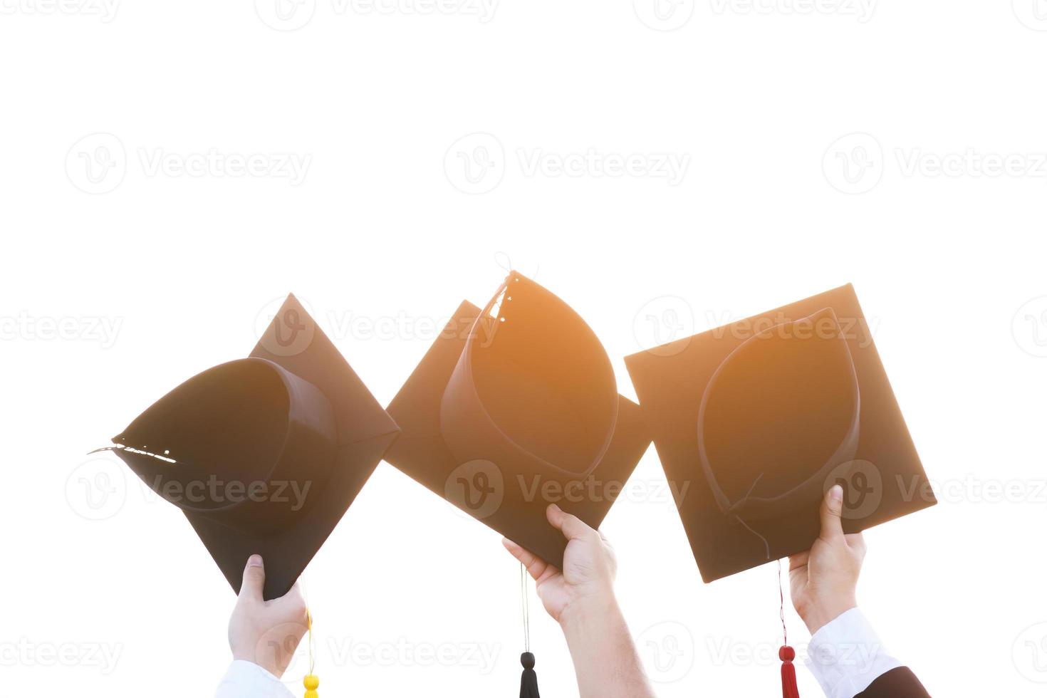 close up graduate hand hold show hat in background school building. Shot of graduation cap during commencement university degree , Education Student Success Learning Concept photo