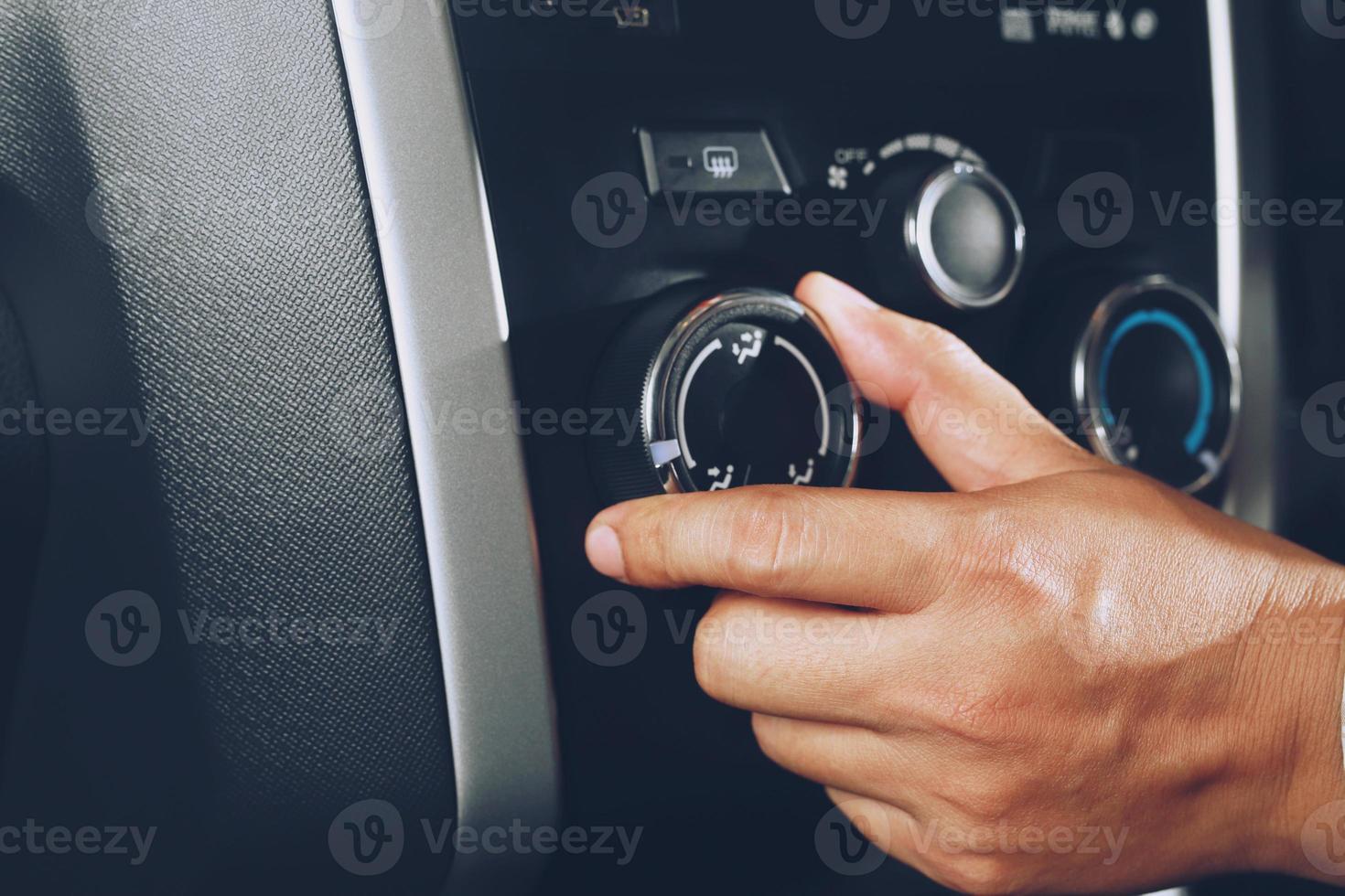 Closeup of hand driver man checking switch adjusting air from conditioning the cooling system with flow of cold in car. Leave space for writing text. photo