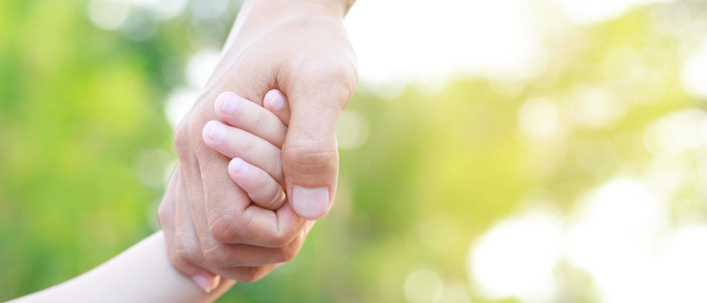 Children's hands with the warmth of mother's care photo