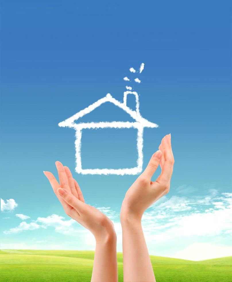 human hands holding model of a house   nature background photo