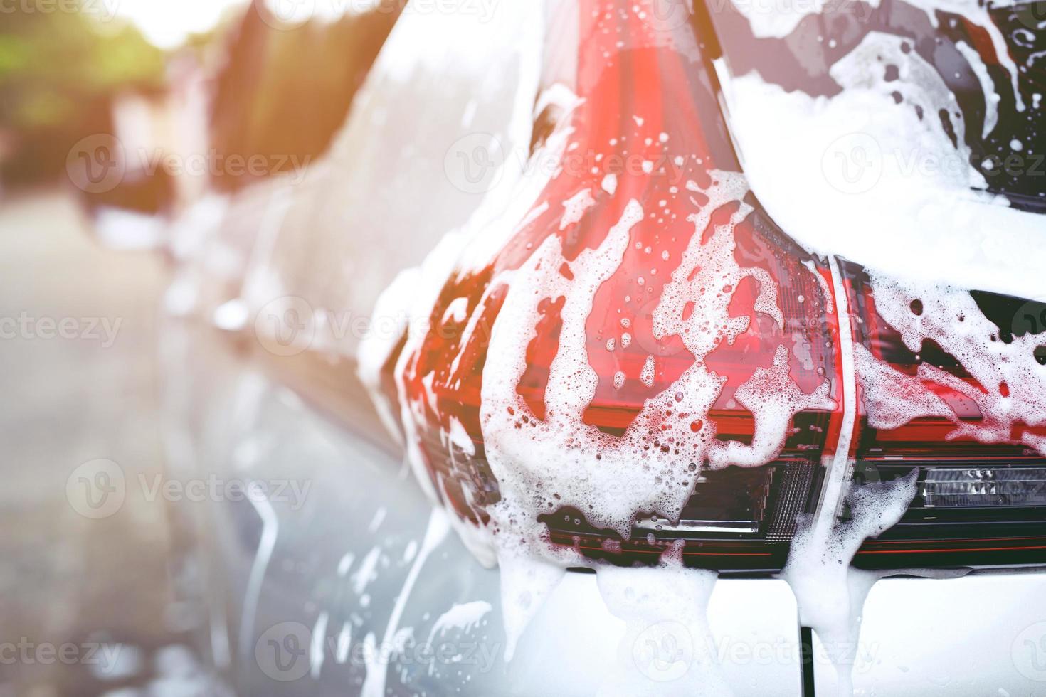 Outdoor car wash foam and soap on black background. abstract pattern , Banner Background Concept. Car Washing and Cleaning Backdrop with Copy Space. photo