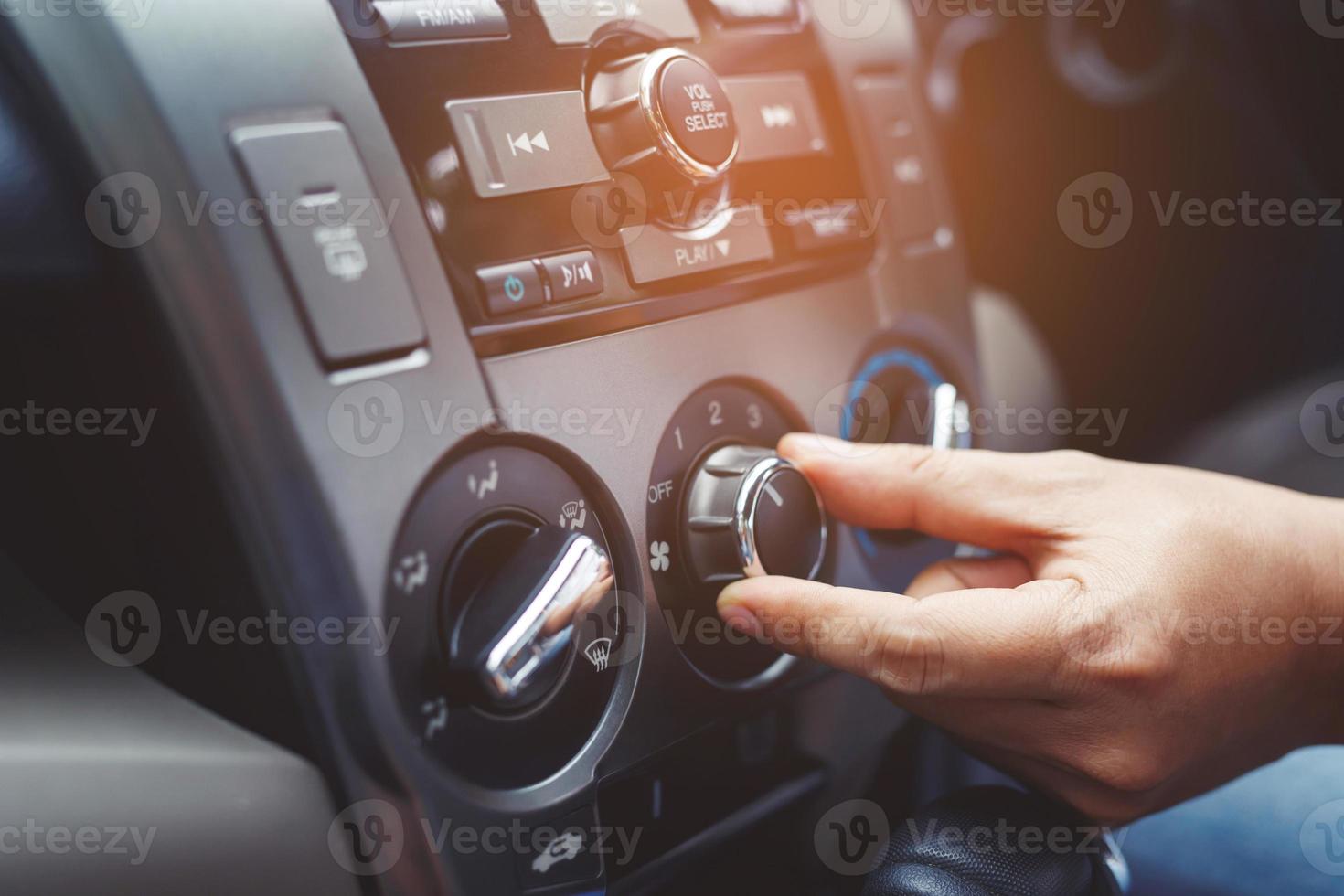 Closeup of hand driver man checking switch adjusting air from conditioning the cooling system with flow of cold in car. Leave space for writing text. photo