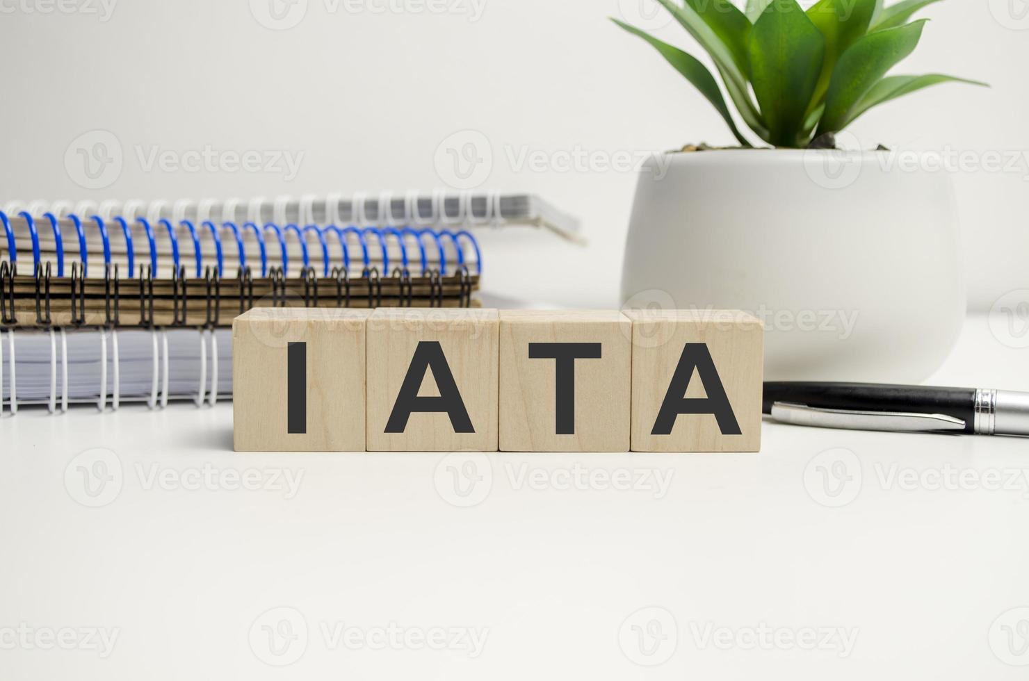 wooden cube block with IATA business word on table background. Mission, Vision and core values concept photo