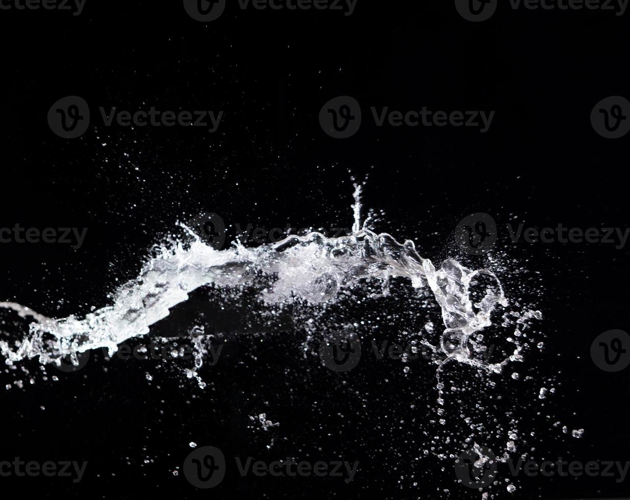 Water splash in air drop over black background, studio lighting high speed photo