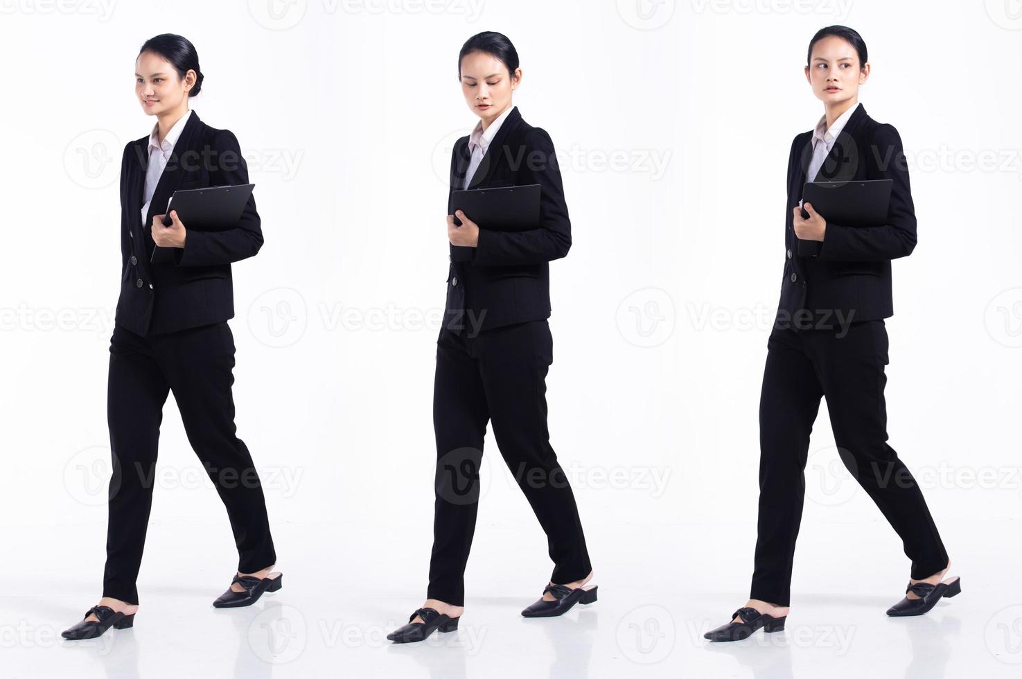 Full length 20s young Mix Race Woman teacher student lawyer, walking forward left right, wear black formal blazer and shoes. Office female feel happy smile over white background isolated photo