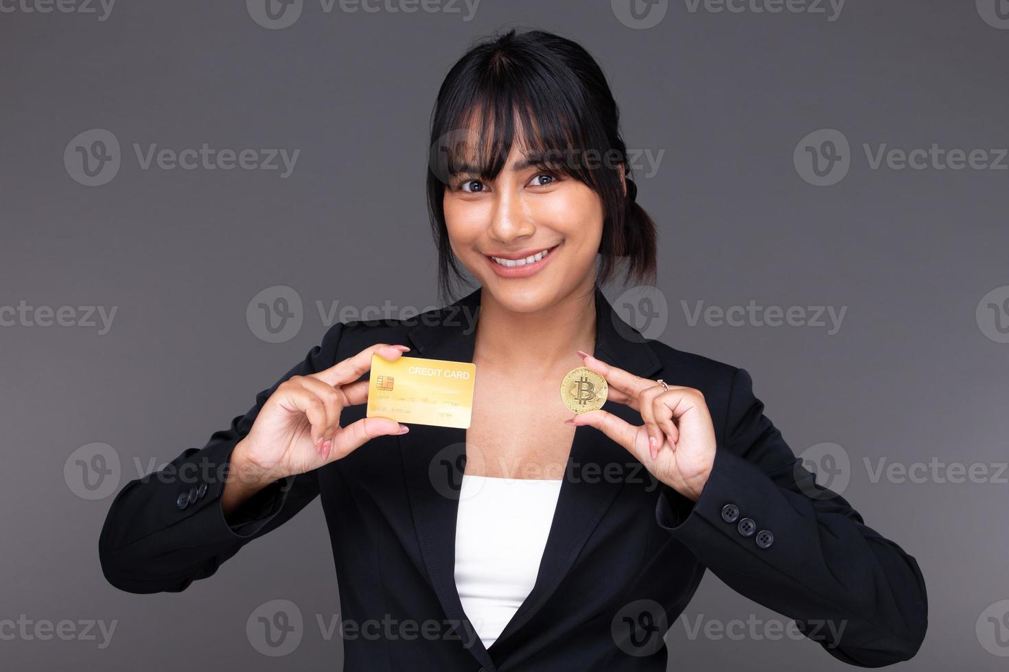 Asian Indian business woman show beautiful smile happy lips, show BTC bitcoin cryptocurrency photo
