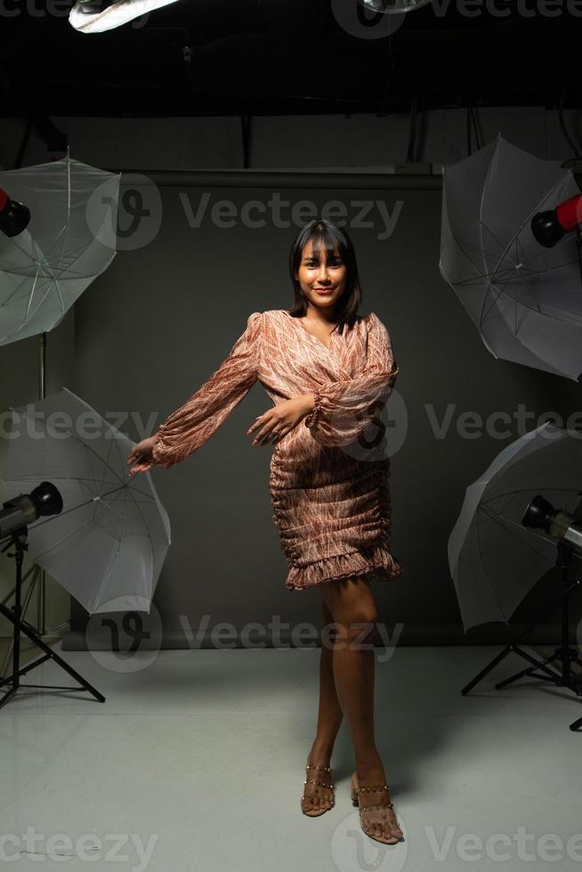 Asian Indian woman show beautiful smile happy lips, fashion poses in photo studio with equipment