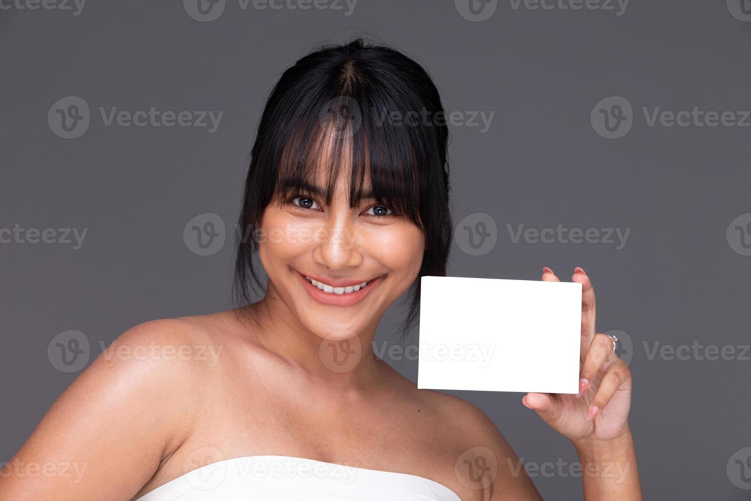 Asian Indian woman show beautiful smile happy lips, hold empty blank package box for treatment skin photo