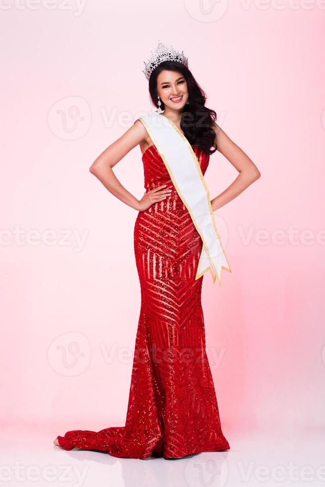 Full Length of Miss Pageant Contest in Asian Red Sequin Evening Ball Gown dress with Silver Diamond Crown Sash, fashion make up face hair style, studio lighting white background isolated copy space photo