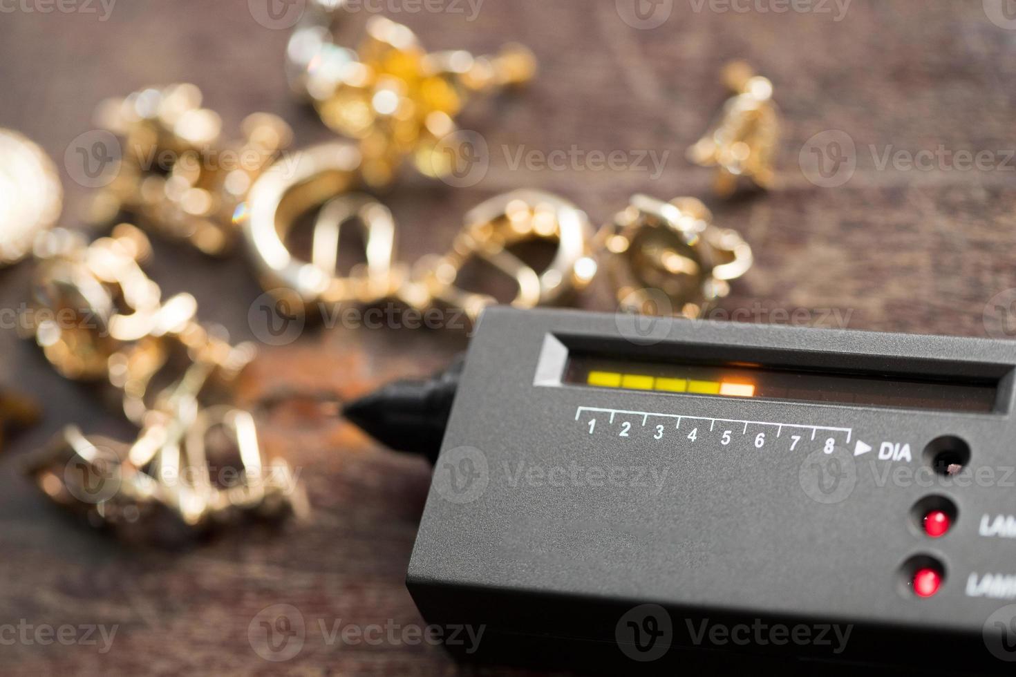 Many expensive decorative Ring, Earrings ready to check real or not with Diamond Tester Gemstone Selector Gems LED Indicator Jewelry kits Test, Portable electronic device to peep quick selective focus photo