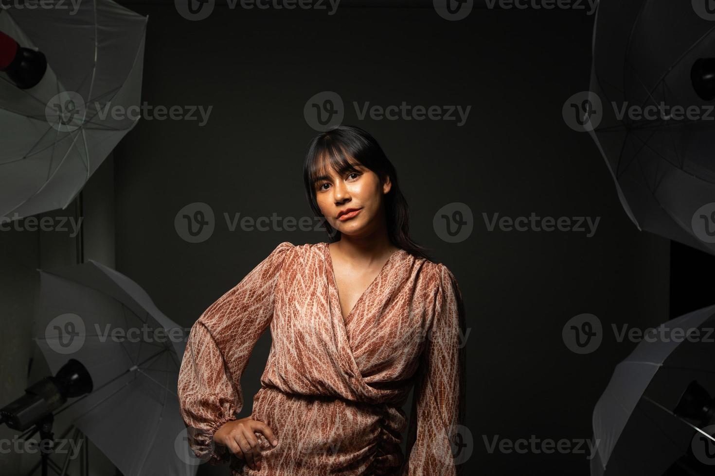 Asian Indian woman show beautiful smile happy lips, fashion poses in photo studio with equipment