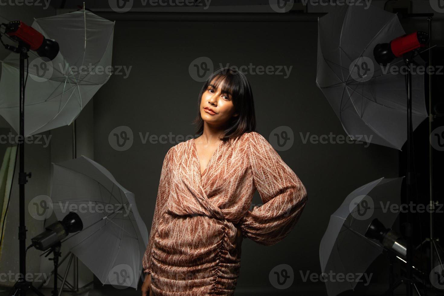 Asian Indian woman show beautiful smile happy lips, fashion poses in photo studio with equipment