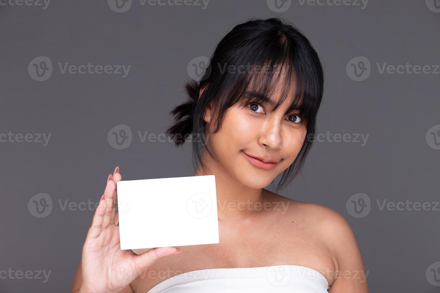 Asian Indian woman show beautiful smile happy lips, hold empty blank package box for treatment skin photo