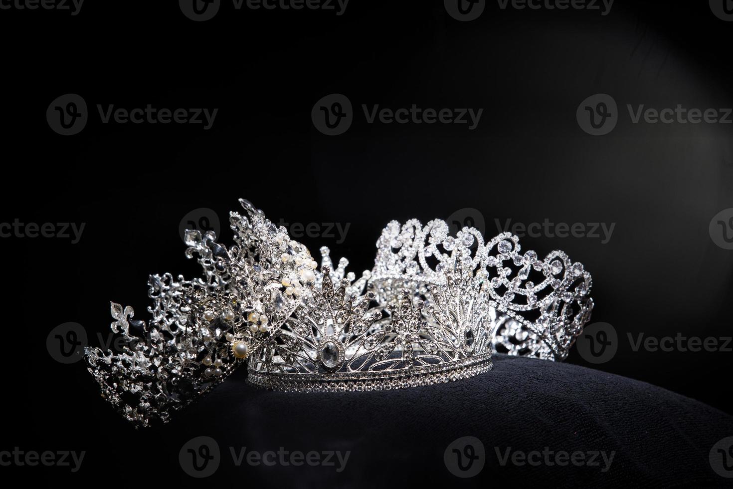 Diamond Silver Crown for Miss Pageant Beauty Contest, Crystal Tiara jewelry decorated gems stone and abstract dark background on black velvet fabric cloth, Macro photography copy space for text logo photo